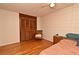 Relaxing bedroom with hardwood floors, a spacious closet, and a cozy chair, perfect for a peaceful retreat at 320 Lakeview St # 208, Orlando, FL 32804