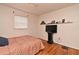 Cozy bedroom featuring hardwood floors, a television, and a ceiling fan, creating a comfortable and functional space at 320 Lakeview St # 208, Orlando, FL 32804