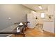 Functional dining area featuring a modern table, a golf bag adding a pop of color, and hardwood floors for a stylish space at 320 Lakeview St # 208, Orlando, FL 32804