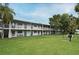 Multi-Gathering building featuring a green lawn, balconies, and mature trees, creating a serene and inviting atmosphere at 320 Lakeview St # 208, Orlando, FL 32804