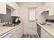 Efficient kitchen with white cabinets, modern appliances, and ample counter space, perfect for cooking and meal preparation at 320 Lakeview St # 208, Orlando, FL 32804