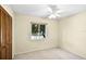 This neutral bedroom features a ceiling fan and a window for ample light at 327 Ketch Ct, Orlando, FL 32835