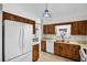 Efficient kitchen featuring wood cabinets, essential appliances, and ample counter space for meal preparation at 327 Ketch Ct, Orlando, FL 32835