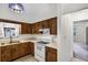 Functional kitchen featuring wood cabinets, ample counter space, and white appliances provides a practical cooking space at 327 Ketch Ct, Orlando, FL 32835