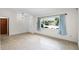 Bright, tiled living room featuring a large window, creating an inviting and airy atmosphere at 327 Ketch Ct, Orlando, FL 32835