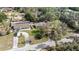 Aerial view of property with mature trees and a long driveway at 35724 Dawn Dr, Leesburg, FL 34788