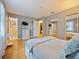 Bedroom with wood floor, mirrored closet and television at 35724 Dawn Dr, Leesburg, FL 34788