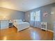 Bright bedroom with wood floor, and white furniture at 35724 Dawn Dr, Leesburg, FL 34788