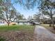Quaint single-story home with mature trees in a tranquil neighborhood setting at 35724 Dawn Dr, Leesburg, FL 34788