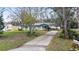 Charming single-story home with a well-maintained lawn and long driveway at 35724 Dawn Dr, Leesburg, FL 34788
