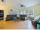 Spacious living room with wood floors and comfortable leather seating arrangement at 35724 Dawn Dr, Leesburg, FL 34788