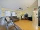 Inviting living room featuring a large sectional sofa and bright, natural light at 35724 Dawn Dr, Leesburg, FL 34788