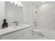 This stylish bathroom features marble-look tile, a shower-tub combination, and a sleek vanity with modern fixtures at 459 Cinnamon Dr, Kissimmee, FL 34759