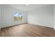 A bright, empty bedroom with vinyl floors and a large window offering plenty of natural light at 459 Cinnamon Dr, Kissimmee, FL 34759