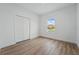 Comfortable bedroom features wood-look flooring, a closet, neutral walls, and a large window that provides natural light at 459 Cinnamon Dr, Kissimmee, FL 34759