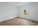 Bright bedroom features wood-look flooring, neutral walls, and a large window that provides plenty of natural light at 459 Cinnamon Dr, Kissimmee, FL 34759