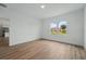 Bright bedroom features wood-look flooring, neutral walls, and a large window that provides plenty of natural light at 459 Cinnamon Dr, Kissimmee, FL 34759
