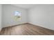 Bright bedroom features wood-look flooring, neutral walls, and a large window that provides plenty of natural light at 459 Cinnamon Dr, Kissimmee, FL 34759