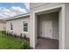Covered home entrance showcasing brick pavers, and clean white trim at 459 Cinnamon Dr, Kissimmee, FL 34759