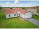 Charming single-story home featuring a red tile roof, fresh lawn, and an attached two-car garage at 459 Cinnamon Dr, Kissimmee, FL 34759