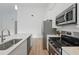 Modern kitchen with stainless steel appliances, white cabinetry, and quartz countertops, with vinyl flooring at 459 Cinnamon Dr, Kissimmee, FL 34759