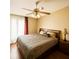 Comfortable bedroom featuring a ceiling fan, natural light, and hardwood floors at 4652 Oak Arbor Cir, Orlando, FL 32808