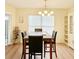 Bright dining room with a wood table, black chairs, and a contemporary chandelier at 4652 Oak Arbor Cir, Orlando, FL 32808