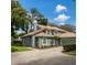 Charming two-story home features a lovely front yard, neutral color scheme, and a tile roof at 4652 Oak Arbor Cir, Orlando, FL 32808