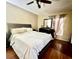 Comfortable bedroom with wood floors, a large bed, dresser, and natural light from the window at 4652 Oak Arbor Cir, Orlando, FL 32808