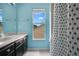 Cozy bathroom featuring a black vanity with a white countertop and blue walls at 468 Wexdon Ct, Lake Mary, FL 32746