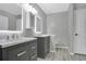 Modern bathroom featuring double sinks, gray cabinets, and stylish lighting fixtures at 468 Wexdon Ct, Lake Mary, FL 32746
