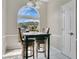 Sunny breakfast nook area with large window, tile flooring and seating for two at 468 Wexdon Ct, Lake Mary, FL 32746