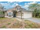 Two-story home featuring neutral paint, a two-car garage, arched windows, and a well-maintained roof in a suburban setting at 468 Wexdon Ct, Lake Mary, FL 32746