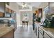 A well-lit kitchen with tile floors, granite countertops, and dark cabinetry; window view into breakfast nook at 468 Wexdon Ct, Lake Mary, FL 32746