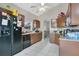 A well-lit kitchen with tile floors, granite countertops, and dark cabinetry; window view into breakfast nook at 468 Wexdon Ct, Lake Mary, FL 32746