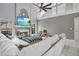 Spacious living room with fireplace, entertainment center, high ceilings, white sectional sofa, and many toys at 468 Wexdon Ct, Lake Mary, FL 32746
