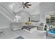 Bright living room with vaulted ceilings, tile floors, stairs, and comfortable white sectional sofa at 468 Wexdon Ct, Lake Mary, FL 32746