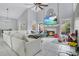 Spacious living room with fireplace, entertainment center, high ceilings, white sectional sofa, and many toys at 468 Wexdon Ct, Lake Mary, FL 32746
