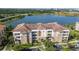 Stunning aerial view of a lakeside apartment complex with beautiful surroundings and ample parking at 4816 Cayview Ave # 20111, Orlando, FL 32819