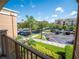 This balcony offers views of the parking area and lush green landscaping at 4816 Cayview Ave # 20111, Orlando, FL 32819