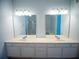 Bathroom features double sinks with large mirrors and good lighting at 4816 Cayview Ave # 20111, Orlando, FL 32819