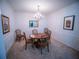 Elegant dining room with chandelier, traditional furnishings, and wainscoting at 4816 Cayview Ave # 20111, Orlando, FL 32819