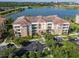 Beautiful condo building with a tile roof overlooking a lake and scenic landscape at 4816 Cayview Ave # 20111, Orlando, FL 32819