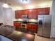 Well-equipped kitchen features stainless steel appliances and dark wood cabinetry at 4816 Cayview Ave # 20111, Orlando, FL 32819