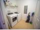 Bright laundry room featuring a washer, dryer, and storage shelves at 4816 Cayview Ave # 20111, Orlando, FL 32819