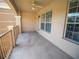 View of the charming covered patio with railings and natural light at 4816 Cayview Ave # 20111, Orlando, FL 32819