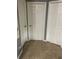 Hallway view featuring three doors, each easily accessible with neutral tile floors at 4843 Pierce Arrow Dr, Apopka, FL 32712