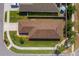 Aerial view of a well-maintained home featuring a brown roof and manicured landscaping at 490 Pentas Ln, Haines City, FL 33844