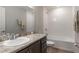 Bright bathroom featuring marble countertop, a large mirror, and a shower-tub combination at 490 Pentas Ln, Haines City, FL 33844