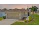 Charming single-story home featuring a two-car garage, neutral paint, manicured lawn, and lovely landscaping at 490 Pentas Ln, Haines City, FL 33844